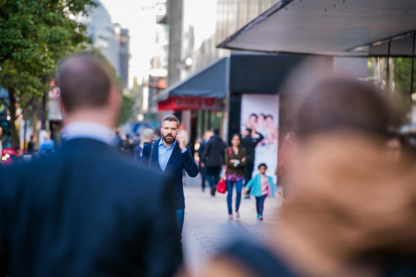 hipster-manager-with-smart-phone-walking-in-the-PFKTPR9(1)