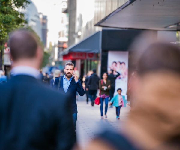 hipster-manager-with-smart-phone-walking-in-the-PFKTPR9(1)