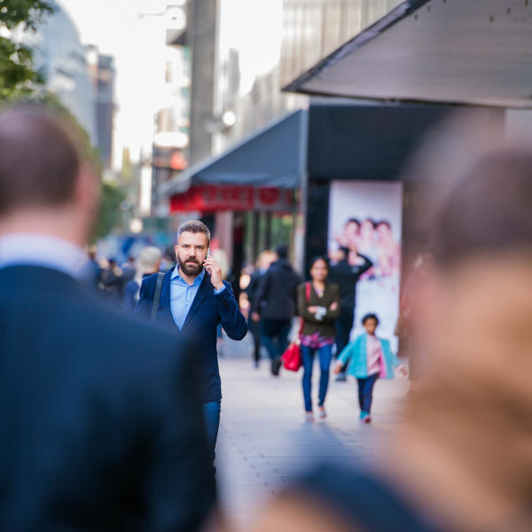 hipster-manager-with-smart-phone-walking-in-the-PFKTPR9(1)