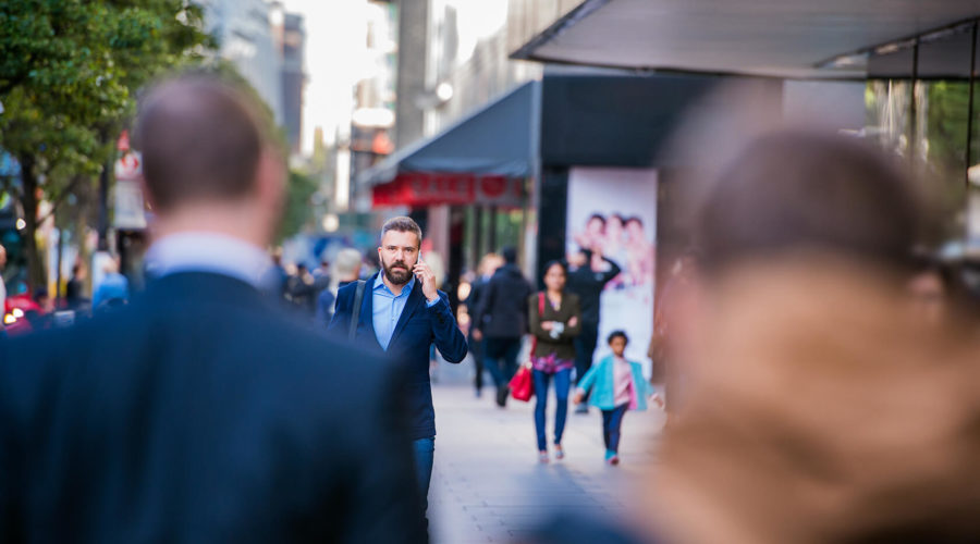 hipster-manager-with-smart-phone-walking-in-the-PFKTPR9(1)